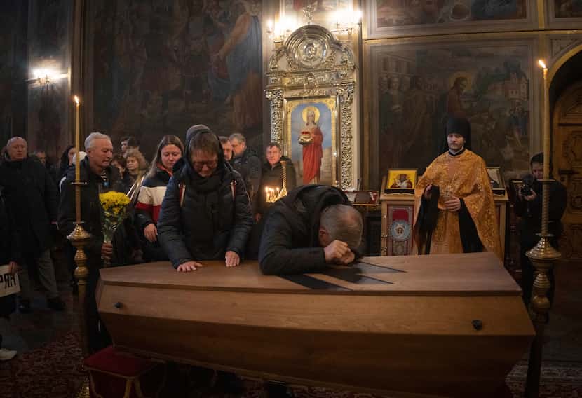 Parents mourn at the a coffin of Oleksandr Grianyk of Azov regiment, who was killed on May 8...