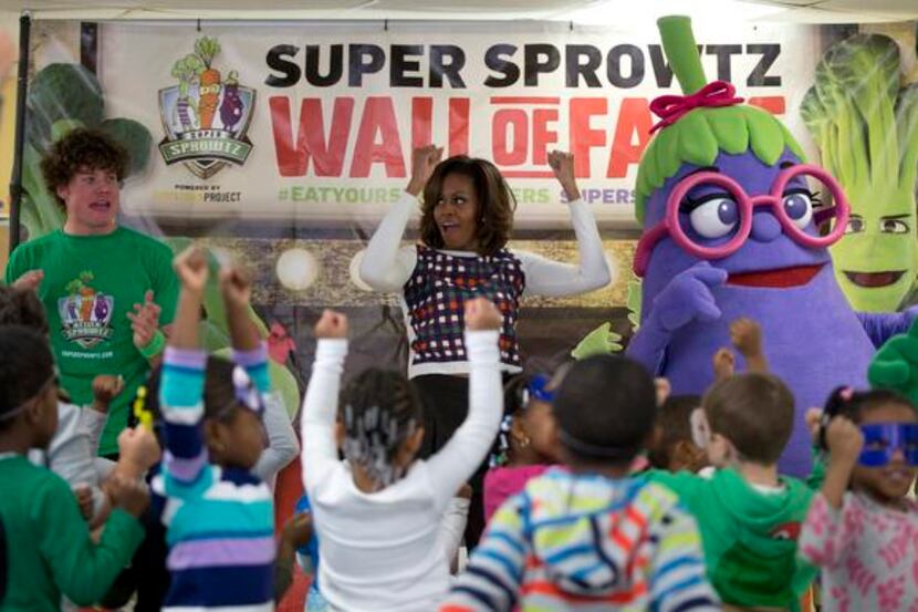 
First lady Michelle Obama exercises and dances with the Super Sprowtz during a visit to La...