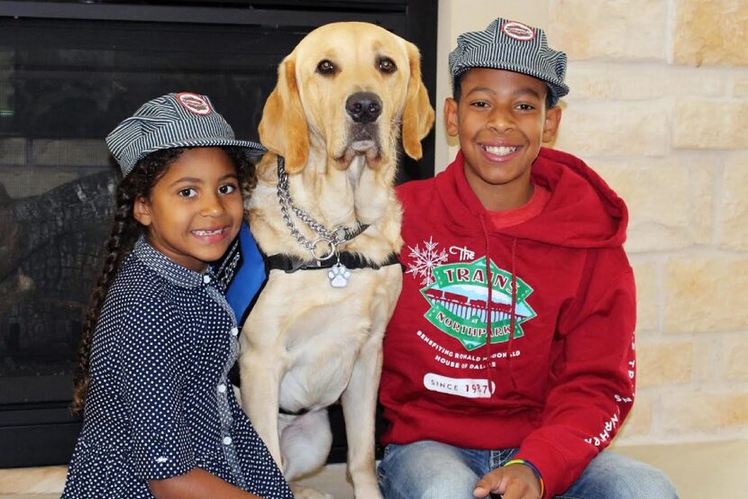 Kid conductors Tatum and Owen Whitmore with "chief cheer officer" Shiloh at the Trains at...