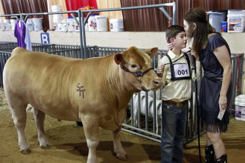 tock Martin got a kiss from his mom, Sherri, before he took his steer, Beast, to the 2019...