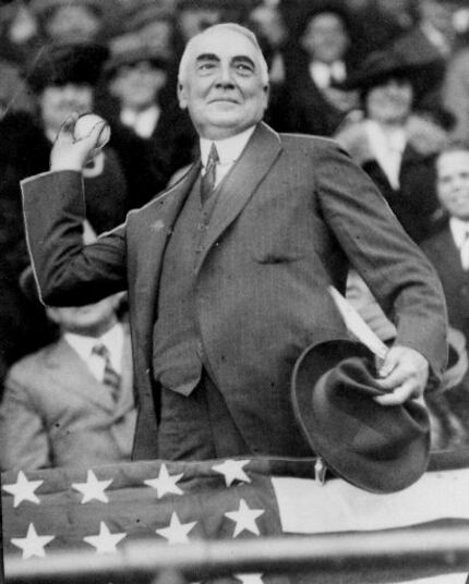 President Warren G. Harding throws out the first ball to open the Washington Senators'...