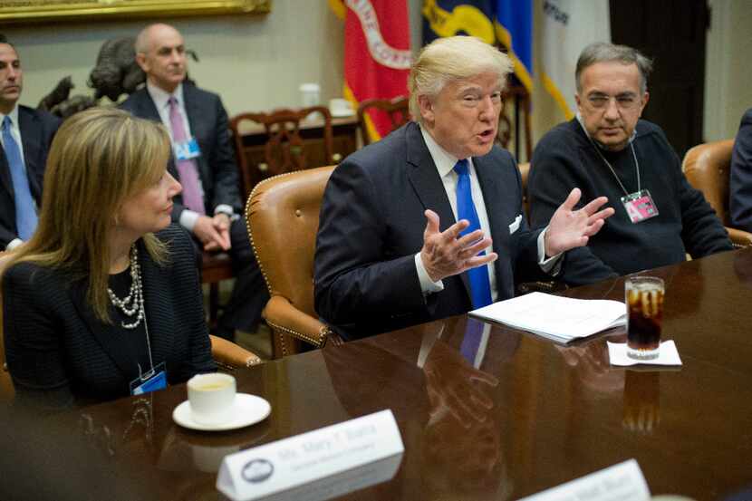 President Donald Trump, flanked by GM CEO Mary Barra and Fiat Chrysler Automobiles CEO...