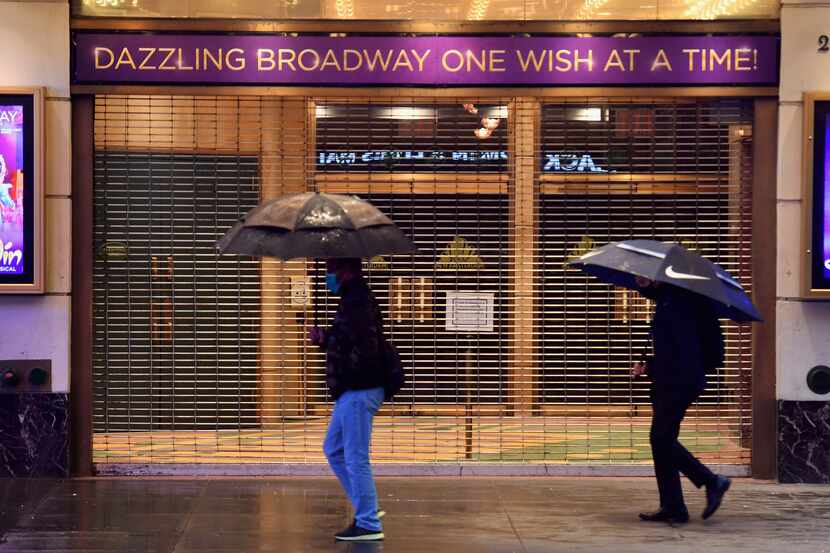 People walk past a closed Broadway theater near Times Square on Oct. 12, 2020 in New York City.