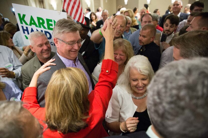 Republican candidate Karen Handel, in red, celebrates her defeat over Democrat Jon Ossoff in...