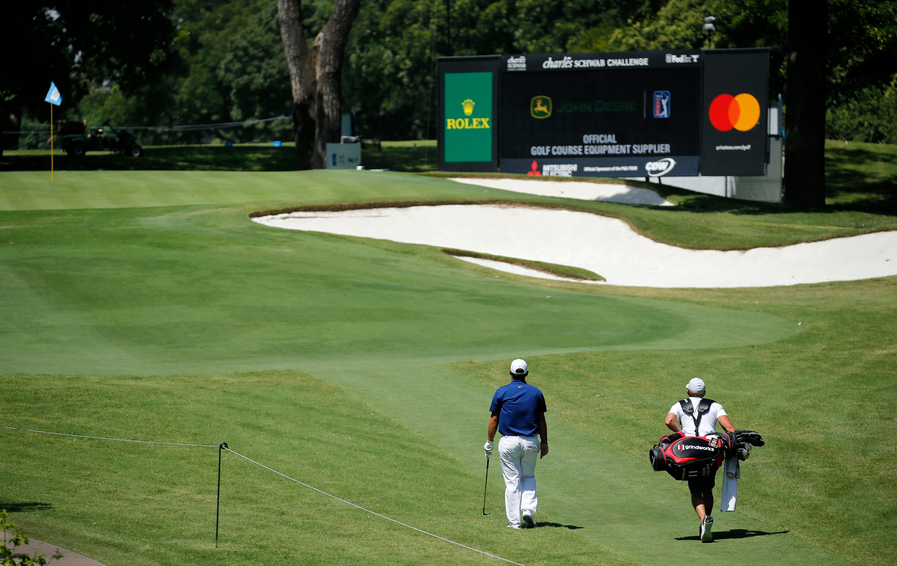 PGA golfer Patrick Reed and his caddie walk alone up the par-3, No. 8 during the Charles...