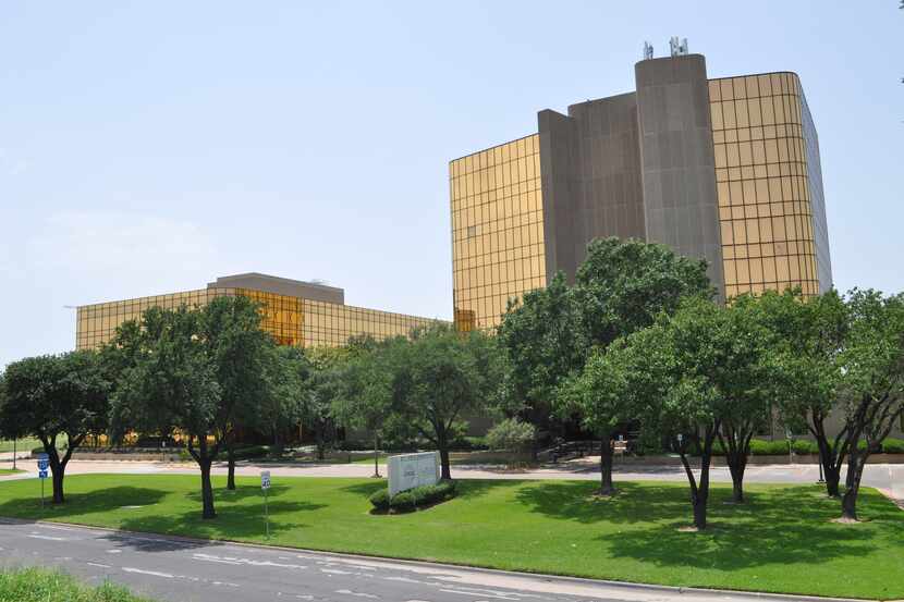 The gold glass Stemmons Freeway buildings were purchased by Dallas-based Ricchi Group.