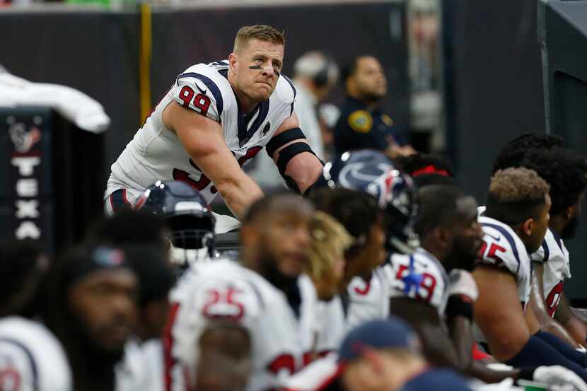 J.J. Watt of the Houston Texans rides a stationary bike on the sideline during the second...