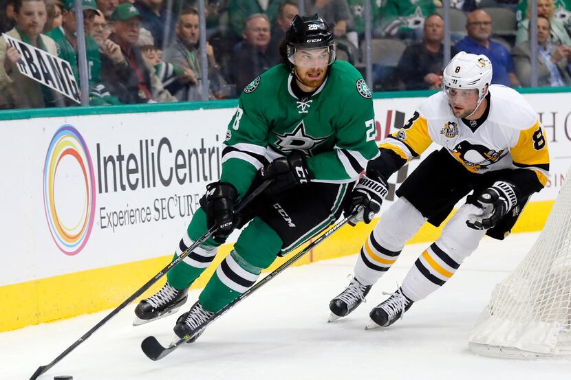Dallas Stars defenseman Stephen Johns (28) controls the puck in front of Pittsburgh...