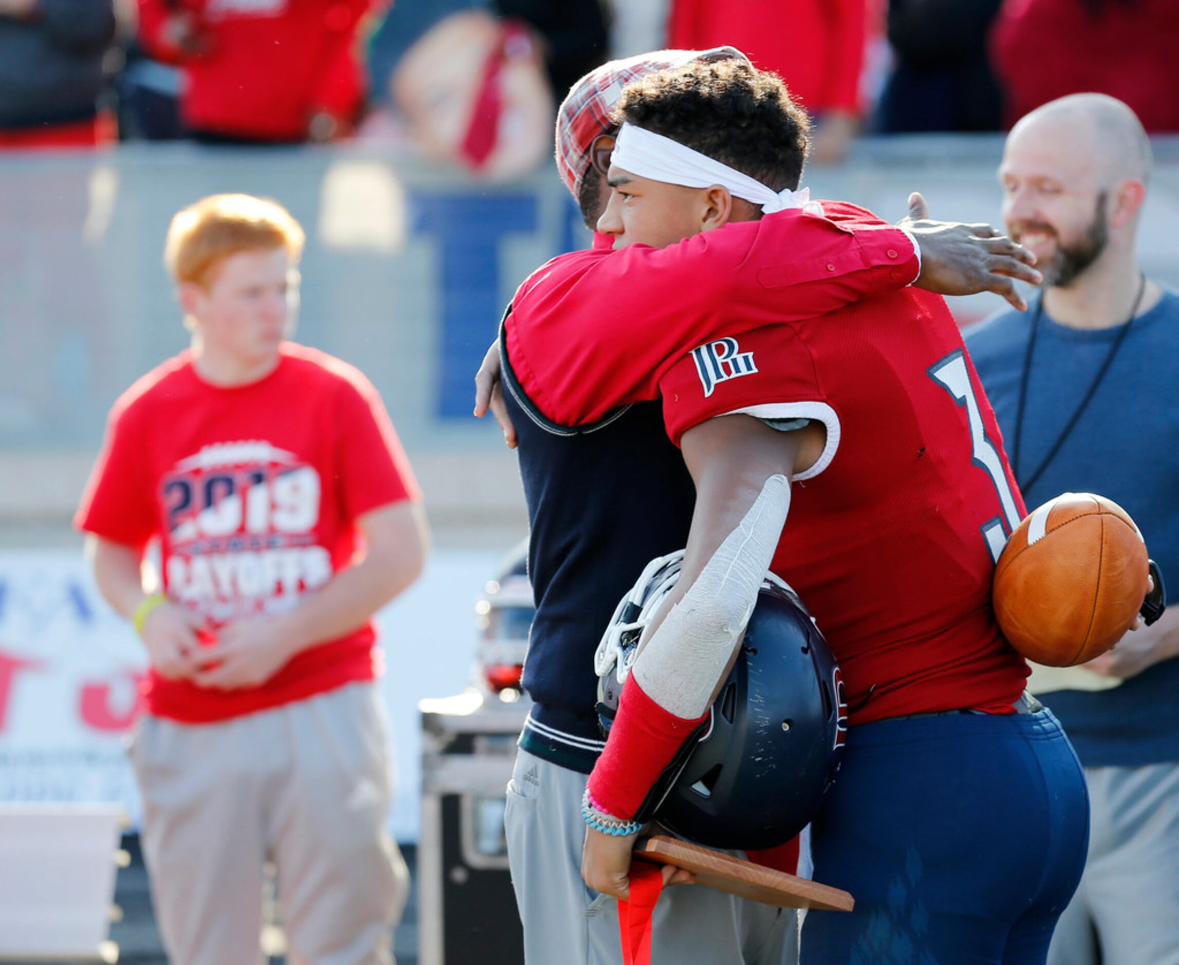 Plano John Paul II's head coach George Teague hugs Grayson James (3) after losing to Parish...