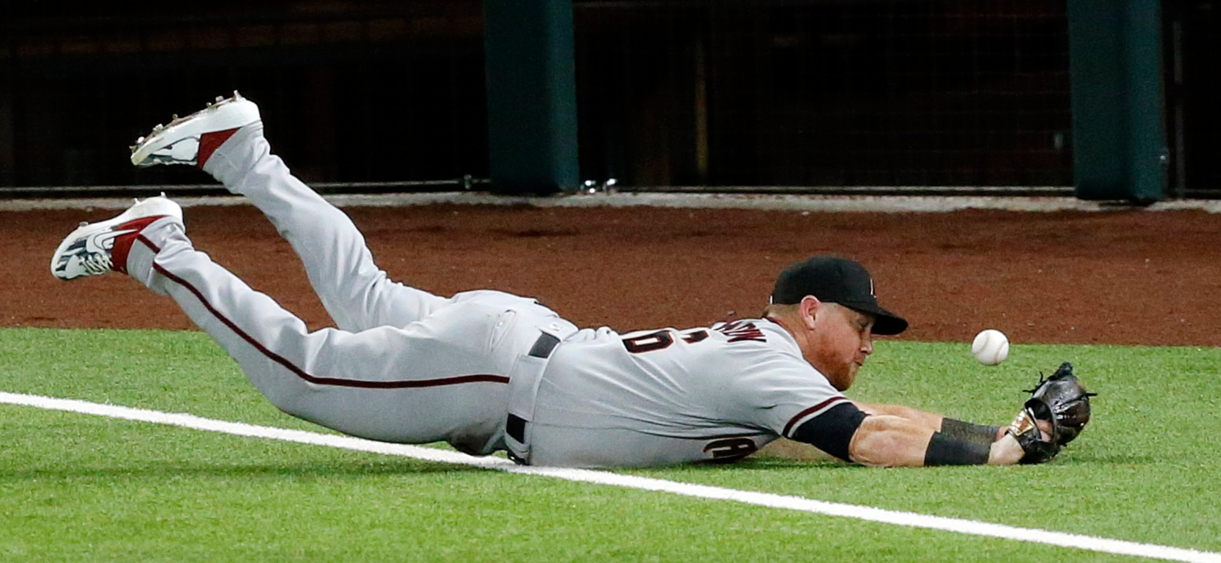 Arizona Diamondbacks right fielder Kole Calhoun (56) dives across the foul line for a pop up...