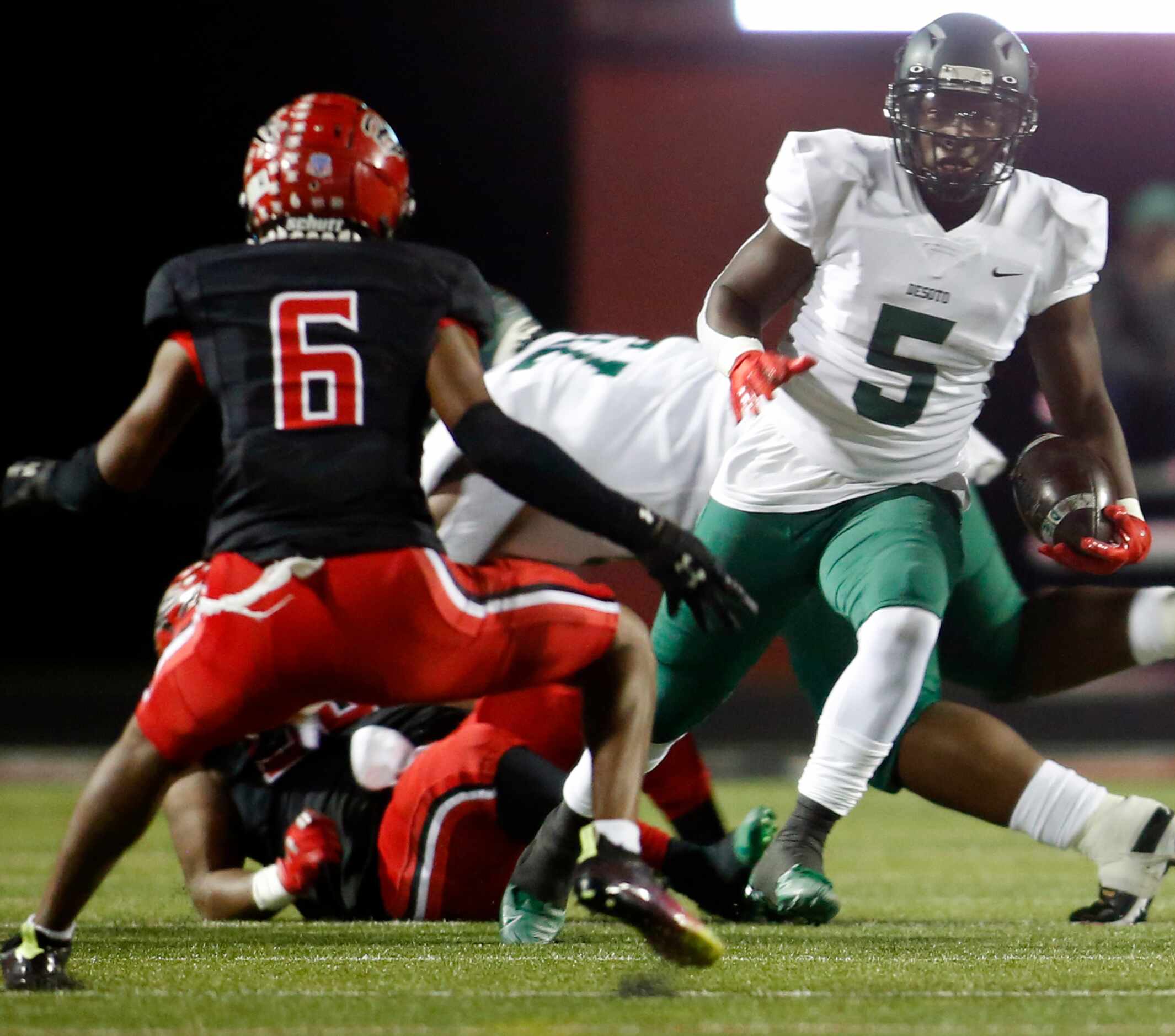 DeSoto running back Chris Henley (5) cuts inside to avoid the defensive pursuit of Cedar...