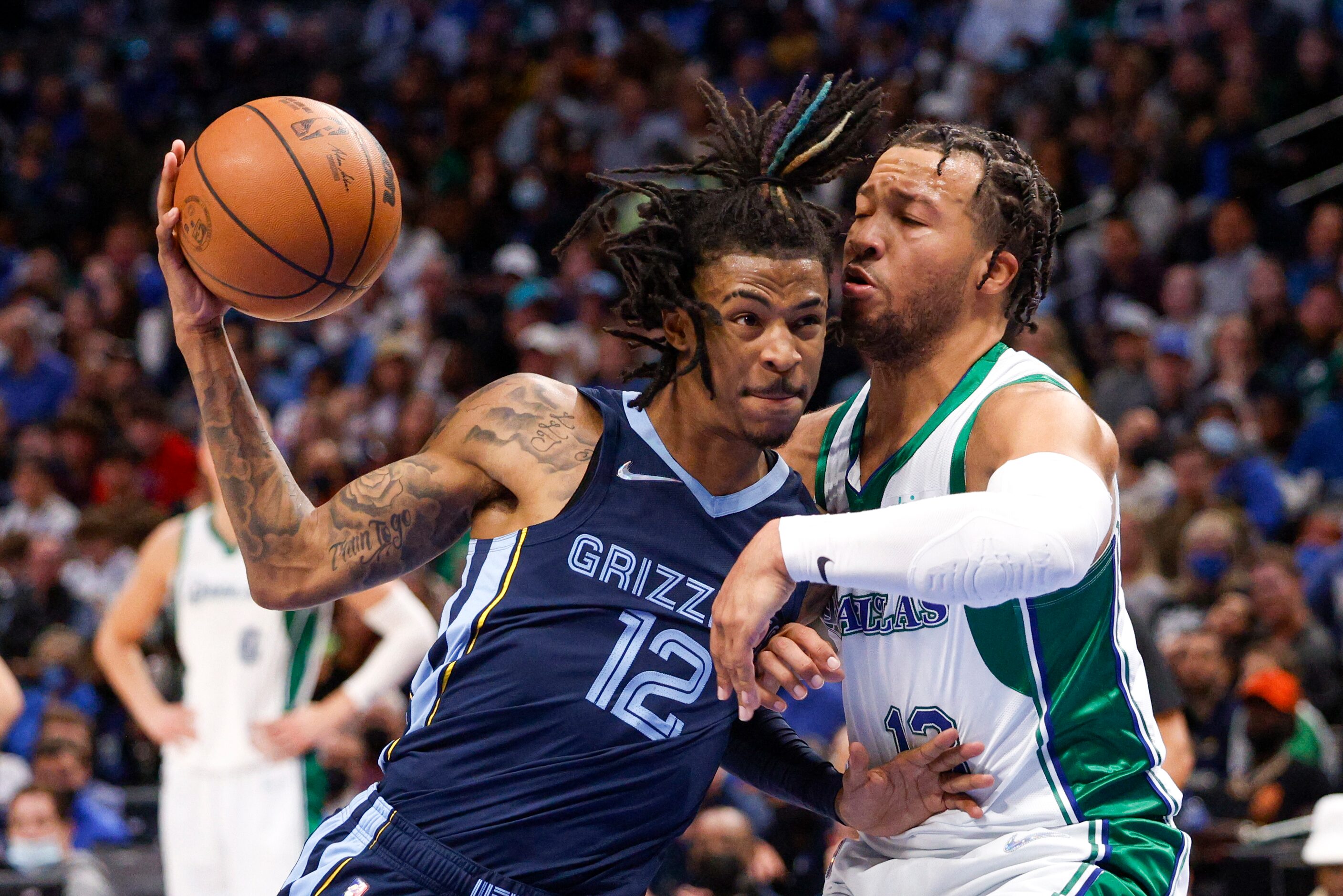 Dallas Mavericks guard Jalen Brunson (13) defends against a driving Memphis Grizzlies guard...