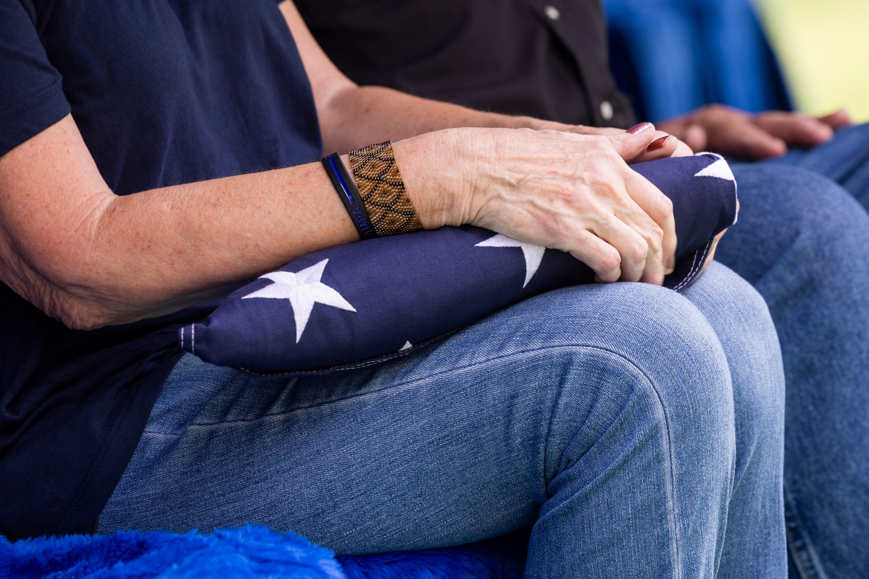 Kimberly Black, daughter of Sgt. Claude Standridge, holds a folded flag as the Dallas Police...