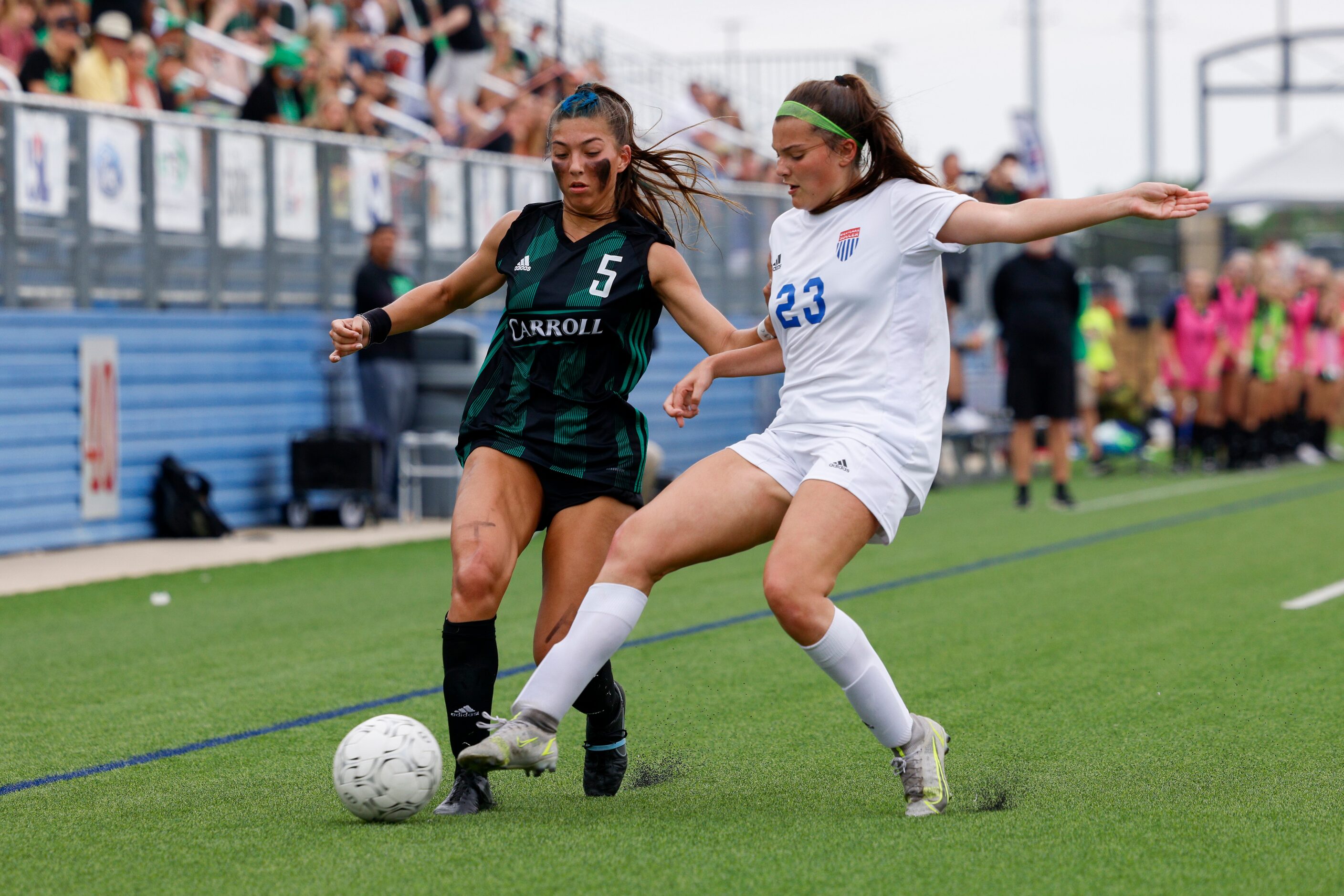 Austin Westlake defender Alex Biles (23) tackles the ball away from Southlake Carroll...