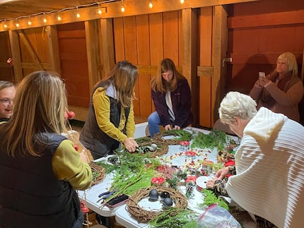 People making wreaths in an old barn