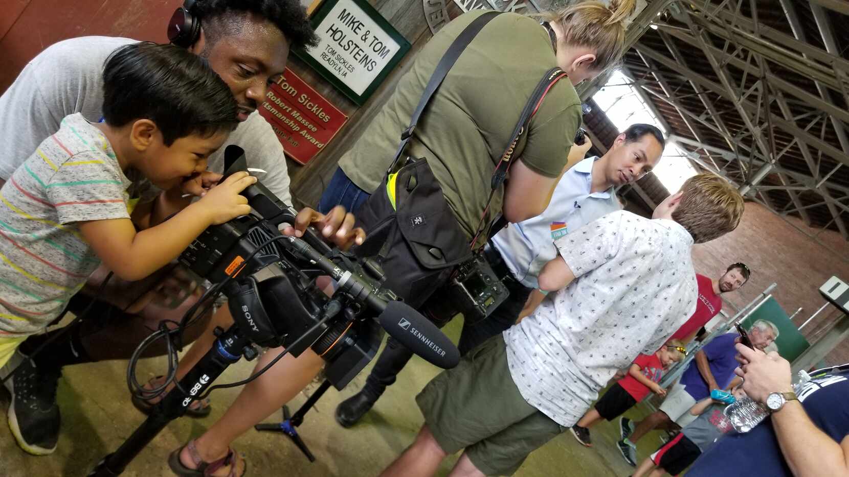 Cristián Castro, 4, peers through a camera with CBS campaign embed Tim Perry as his dad,...