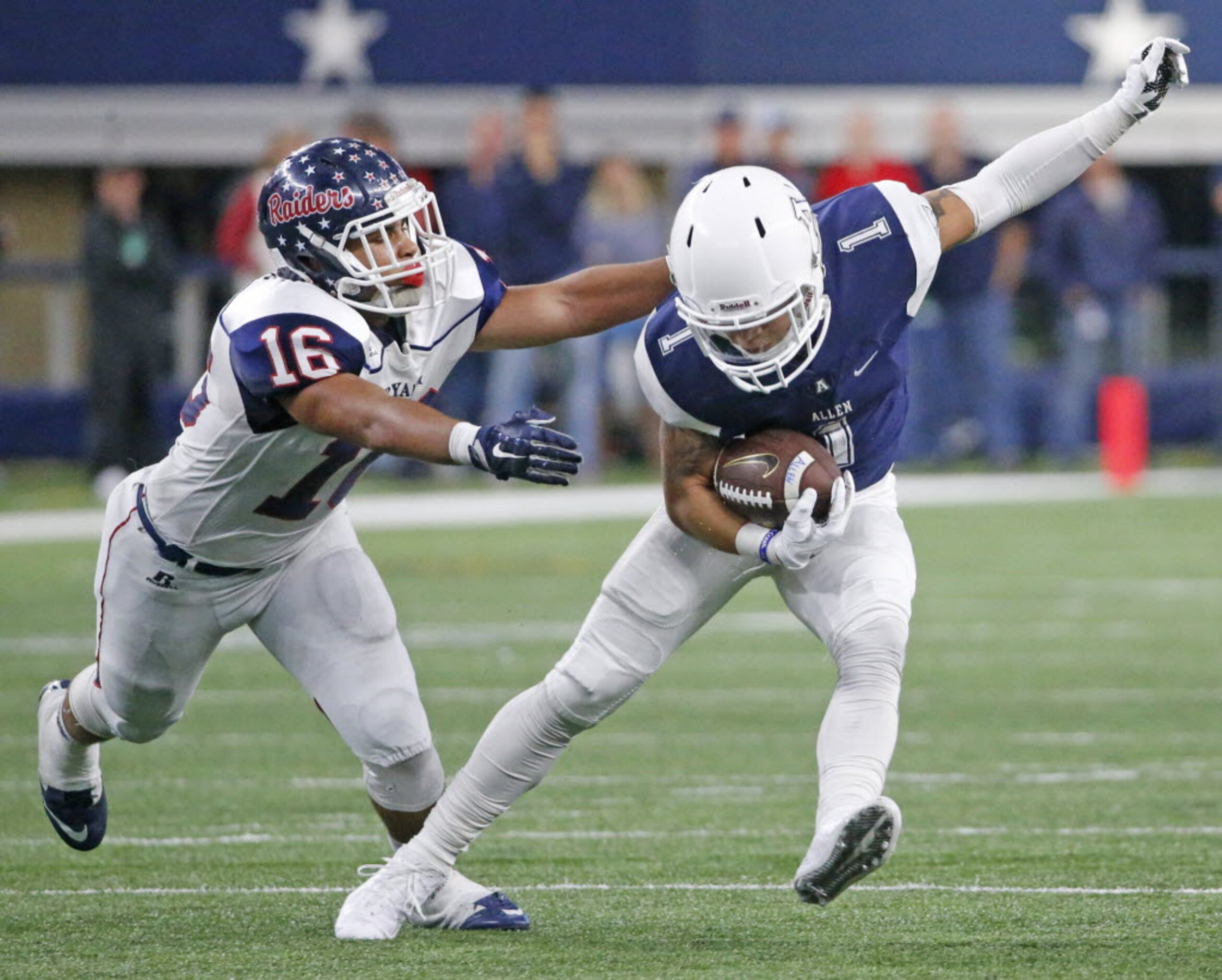 Allen receiver Kerry Hall (1) tries to get away from the grasp of Ryan defender Jason Gulley...