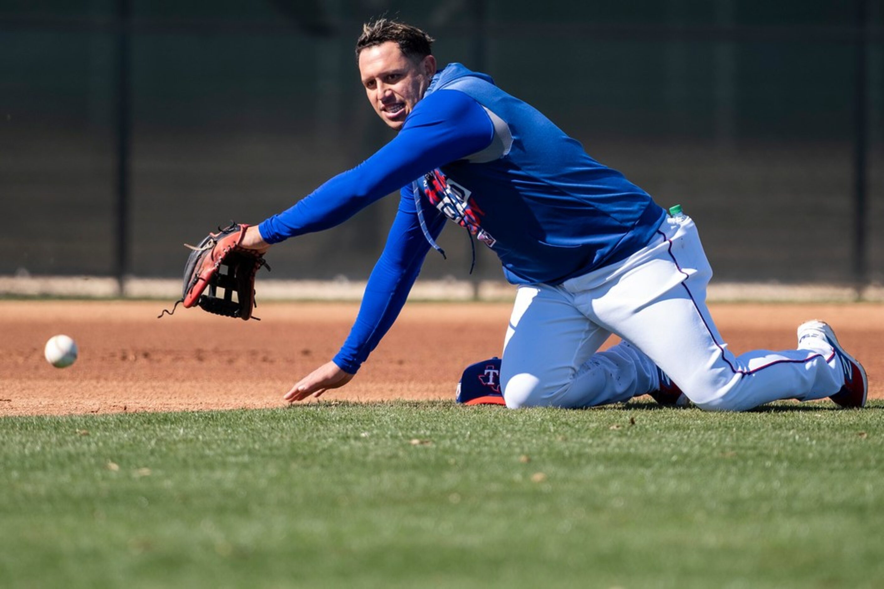 Texas Rangers infielder Asdrubal Cabrera participates in a fielding drill during a spring...