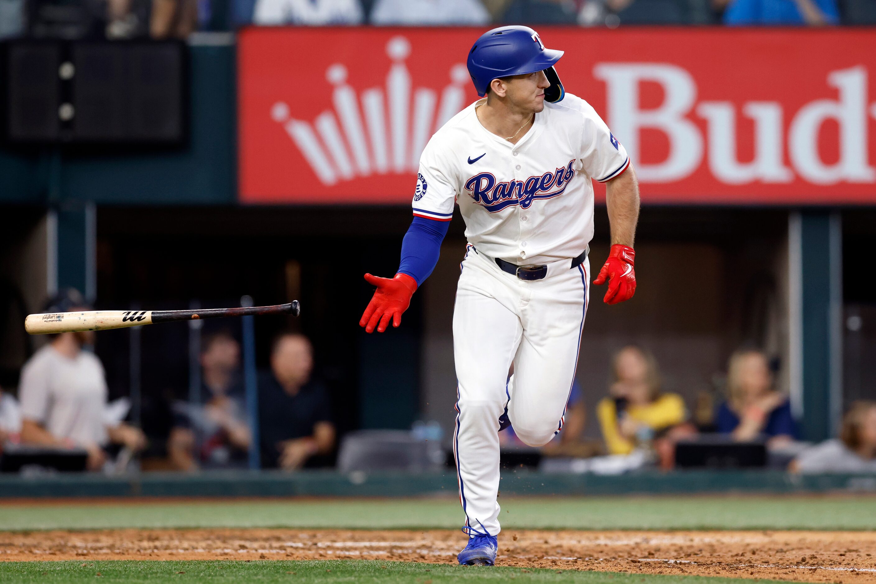 Texas Rangers left fielder Wyatt Langford (36) tosses his bat after hitting his first career...