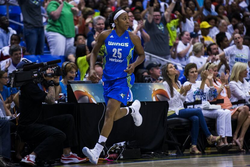 Dallas Wings forward Glory Johnson (25) runs across the court as fans cheer after she scored...