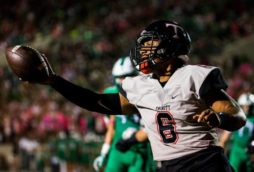 Euless Trinity quarterback Malini Maile (6) celebrates as he runs in to the end zone for a...