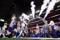 Dallas Cowboys wide receiver Brandin Cooks (3) and quarterback Trey Lance (15) ran through a...
