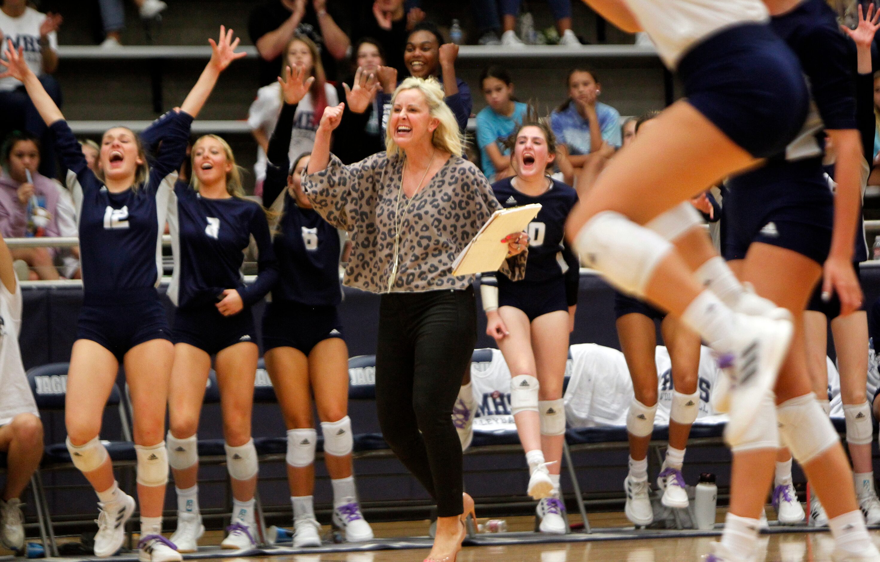 Flower Mound head coach Jamie Siegel, center, celebrates with Jaguars players after scoring...