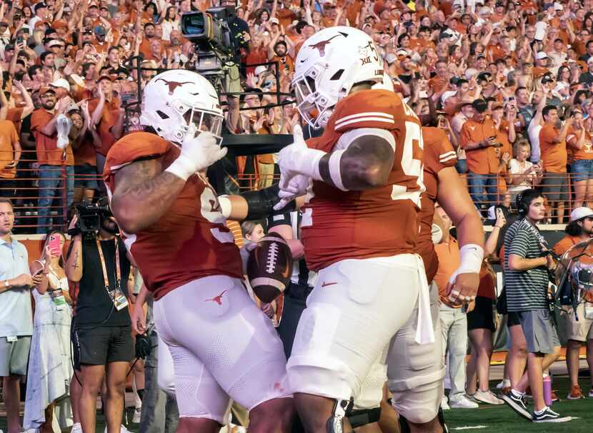 Texas defensive lineman Byron Murphy II, left, who was an eligible receiver, celebrates his...