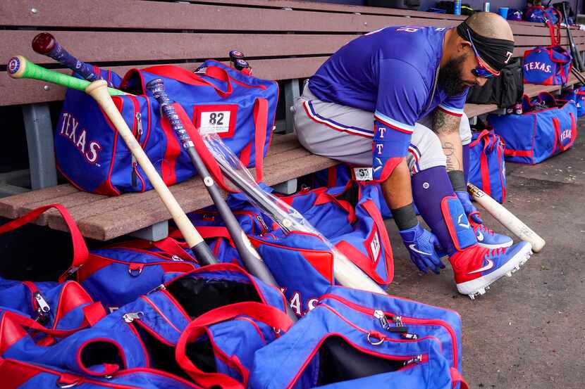 Texas Rangers second baseman Rougned Odor puts on his gear before a spring training game...