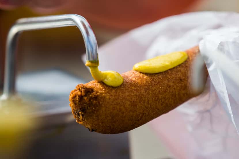 The "right" way to eat a Fletcher's corny dog at the State Fair of Texas is with mustard,...
