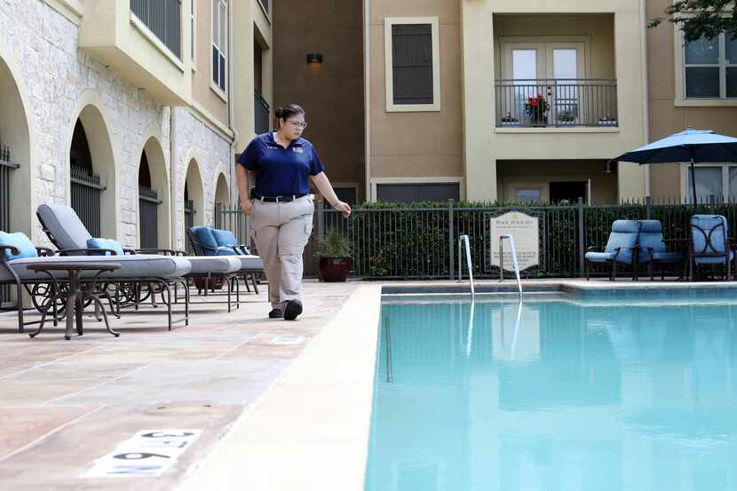 Amy Del Toro scans the pool for any possible safety issues at The Landon at Lake Highland...