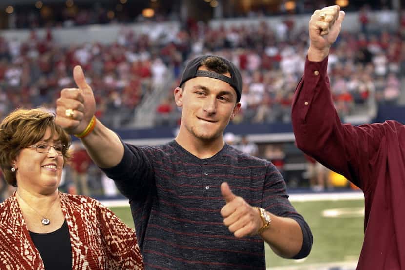 Former Texas A&M Aggies quarterback Johnny Manziel receives his Aggie Ring from his academic...