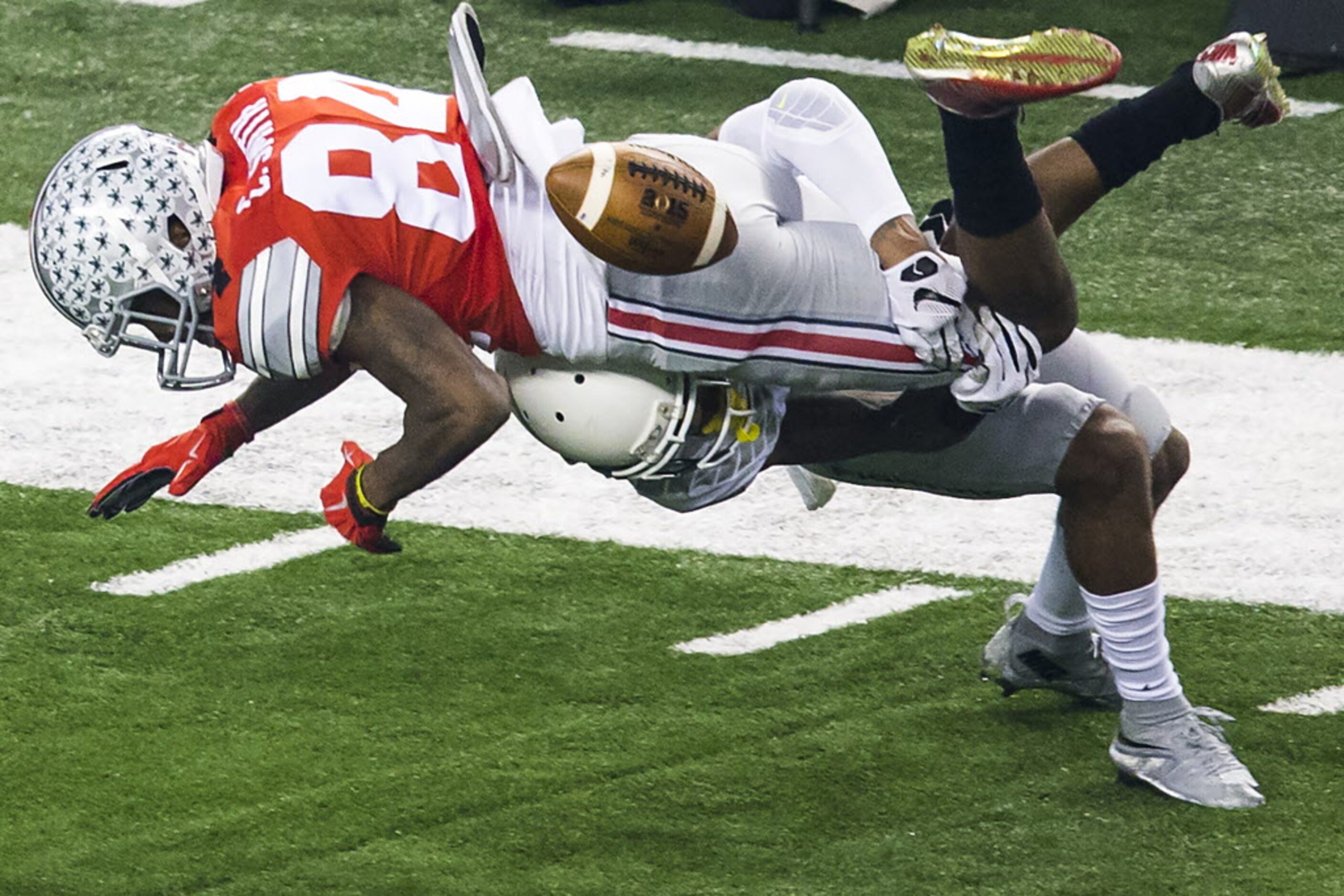 Ohio State Buckeyes wide receiver Corey Smith (84) fumbles as he is hit by Oregon Ducks...