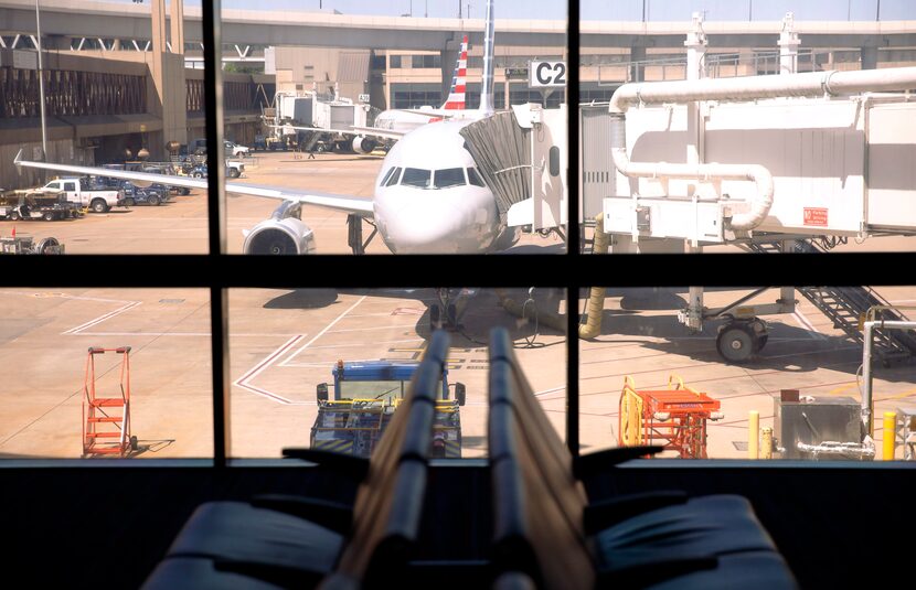 Empty chairs at a gate in Terminal C at DFW International Airport on Wednesday, April 8, 2020. 