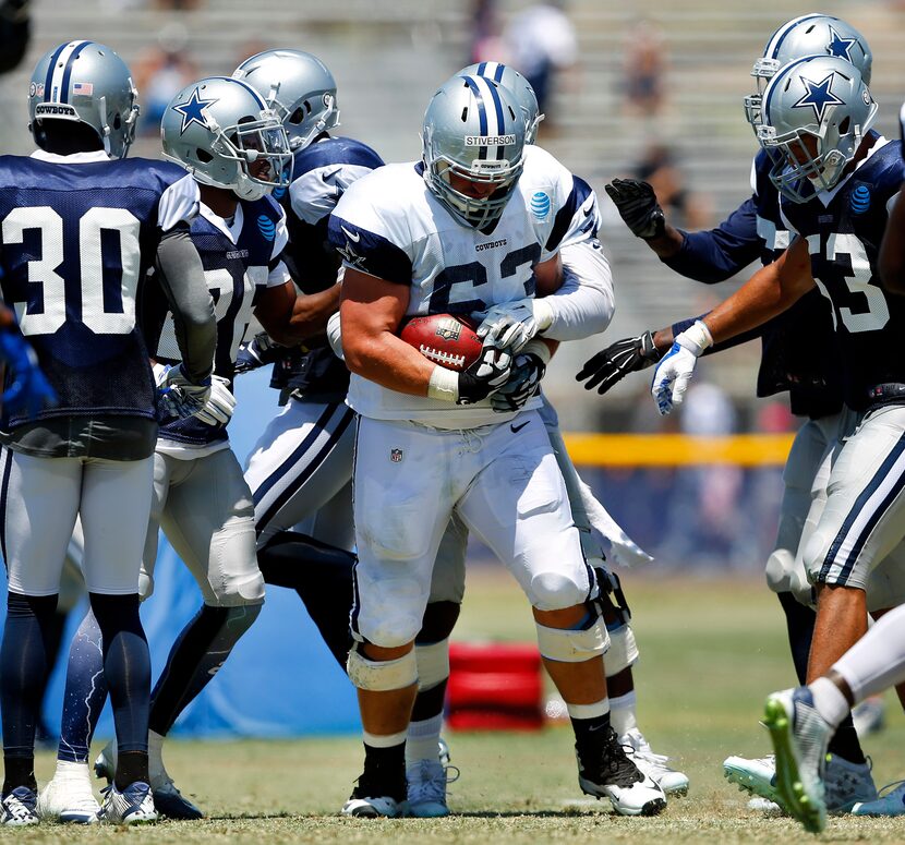 Dallas Cowboys offensive guard Boston Stiverson (63) finds the ball in his hands after a...