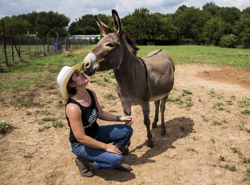 Jess Anselment kisses her donkey, Bunny.
