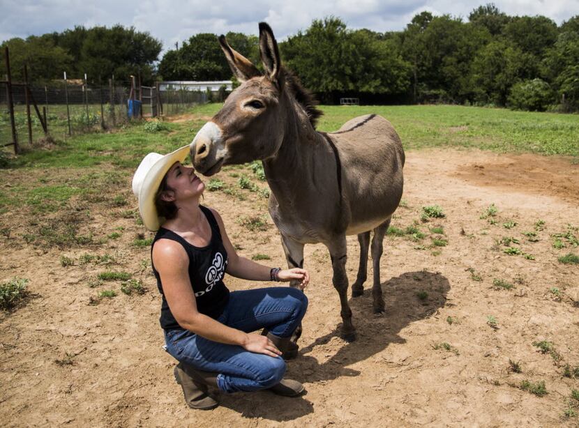 Jess Anselment kisses her donkey, Bunny.