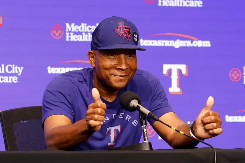 Texas Rangers third base coach Tony Beasley gives a thumbs up after a press conference and...