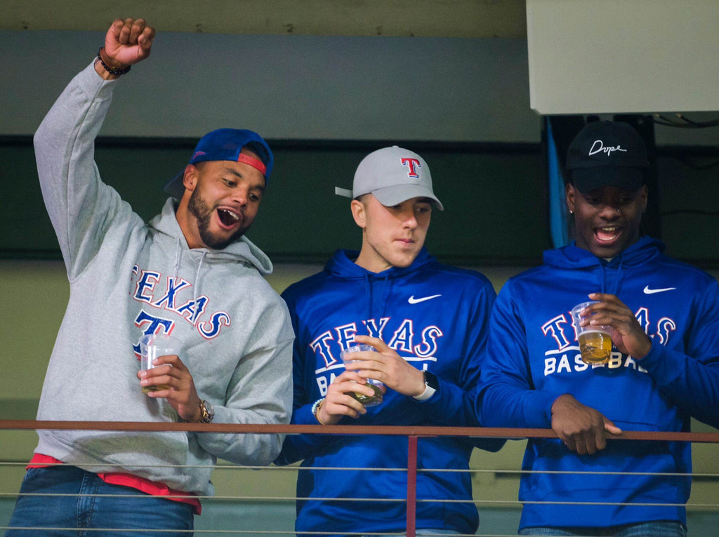 Dallas Cowboys quarterback Dak Prescott (left) cheers for the Texas Rangers during the fifth...