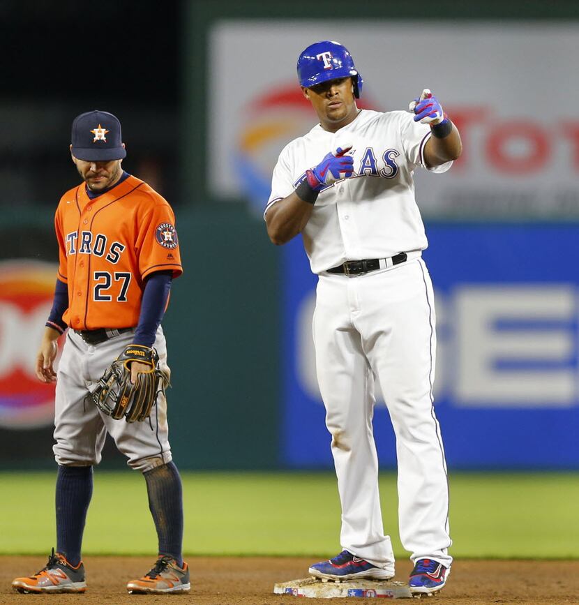 Texas Rangers third baseman Adrian Beltre (29) points to the dugout after stroking an eighth...