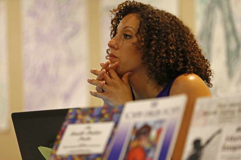 Sara Mokuria, co-founder of Mothers Against Police Brutality, listens to a speaker during...