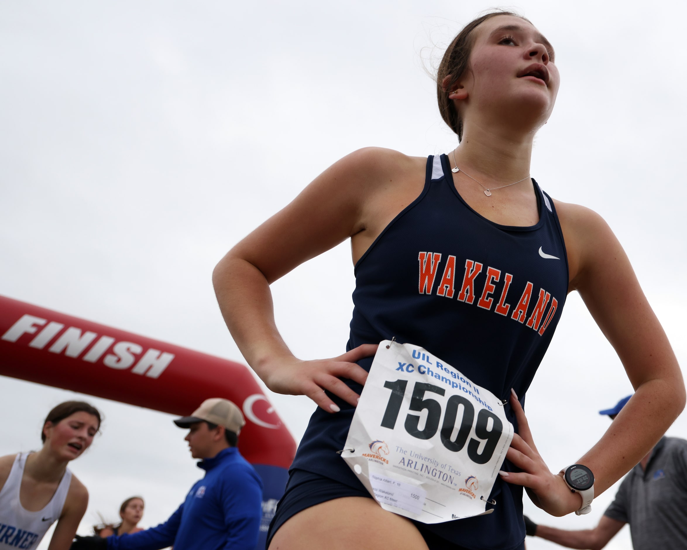 Frisco Wakeland sophomore Sophia Altieri pauses to catch her breath after crossing the...