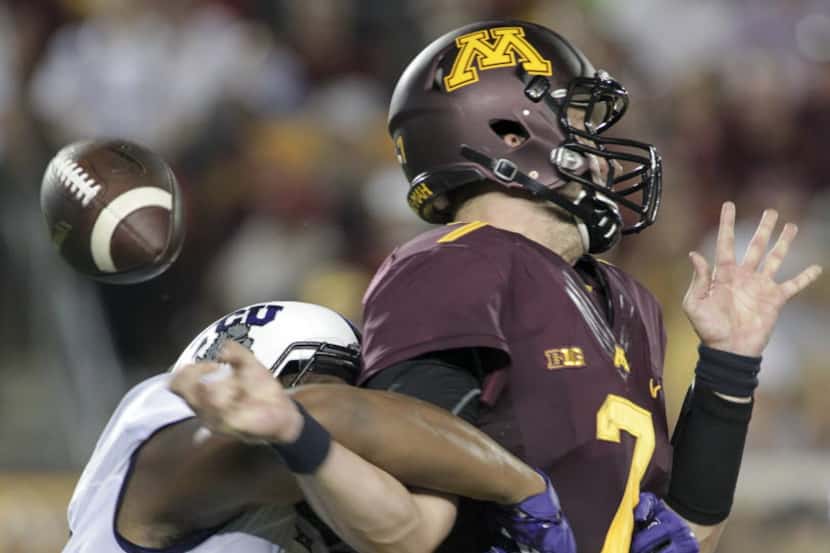 Minnesota quarterback Mitch Leidner (7) is stripped of the ball by TCU defensive end Terrell...