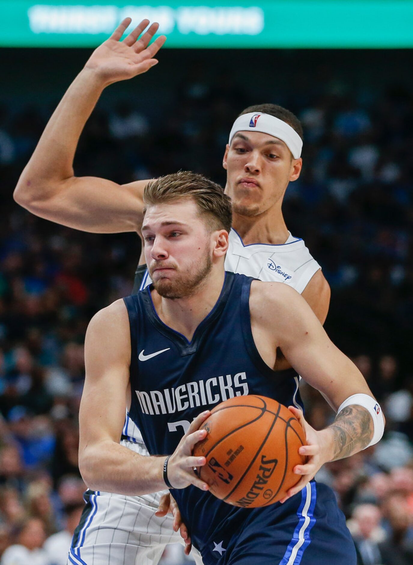 Dallas Mavericks guard Luka Doncic (77) breaks past Orlando Magic forward Aaron Gordon (00)...