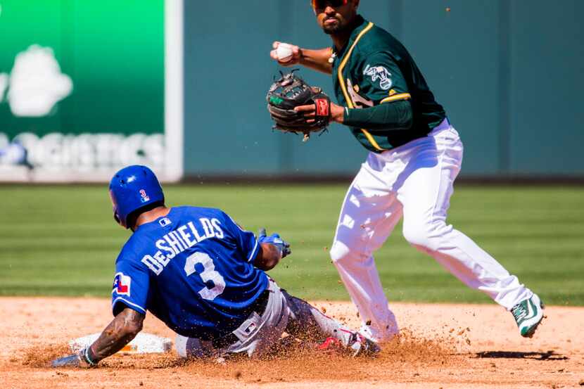 Texas Rangers center fielder Delino DeShields (3) is out at second as Oakland Athletics...