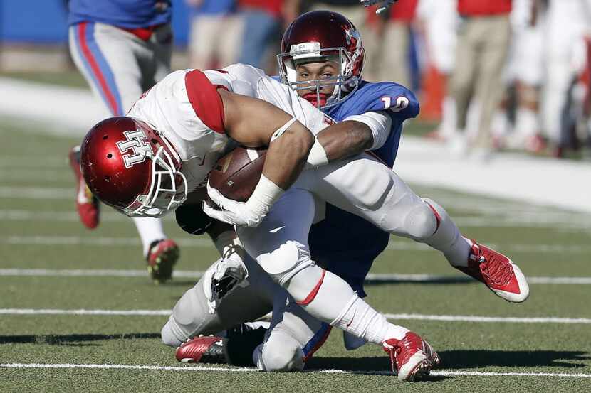 SMU defensive back Ajee Montes (10) tackles Houston running back Kenneth Farrow (35) during...