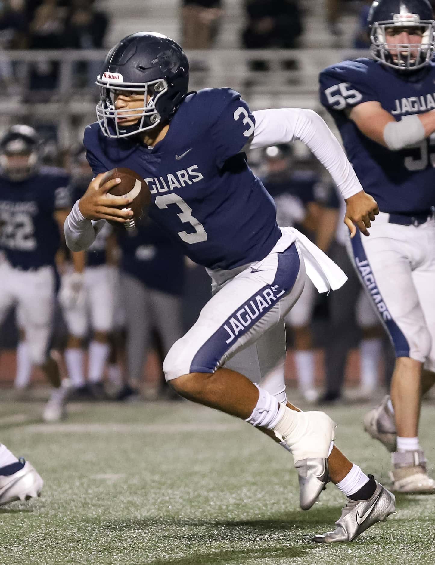 Flower Mound quarterback Nick Evers (3) scrambles out of the backfield against Mansfield...