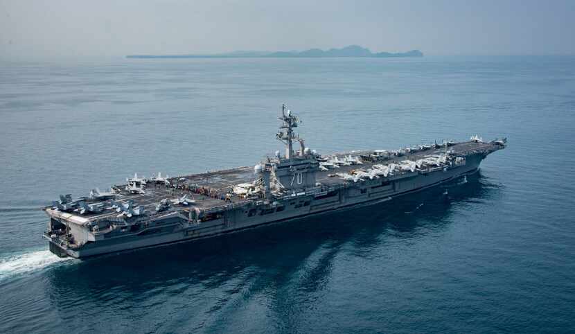 In this U.S. Navy photo, the aircraft carrier USS Carl Vinson transits the Sunda Strait on...
