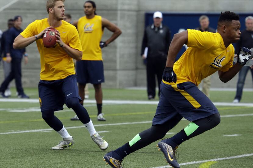 California quarterback Jared Goff, left, prepares to pass during California's NFL Pro Day...