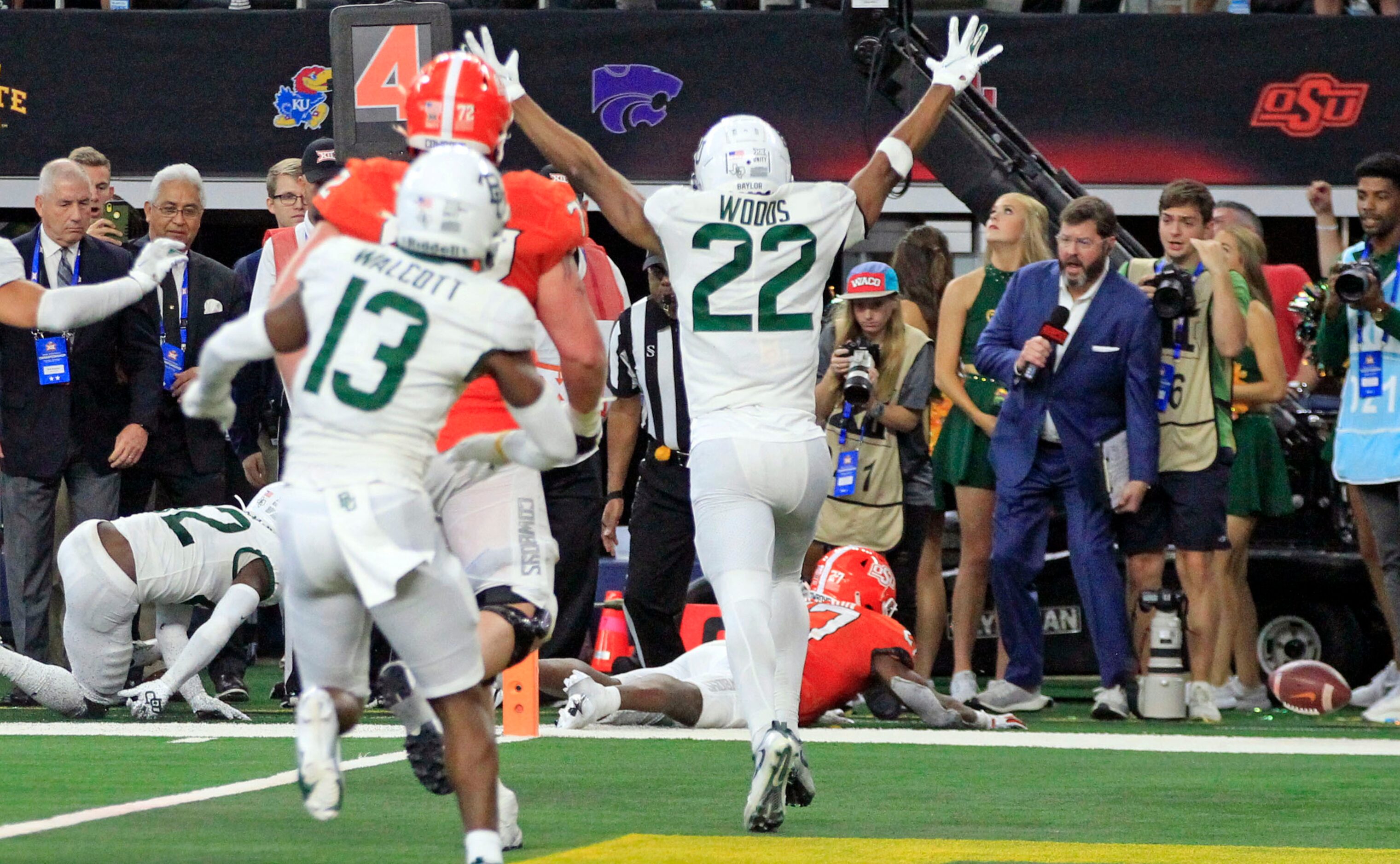 The football rolls away, and Baylor Bears safety JT Woods (22) celebrates, as Oklahoma State...